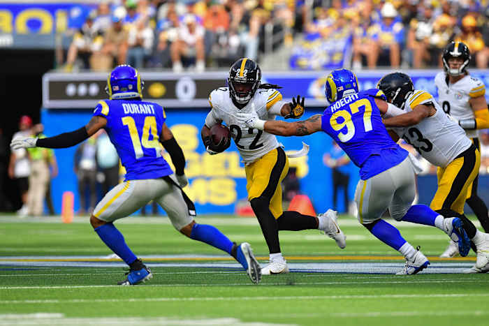Pittsburgh Steelers running back Najee Harris (22) runs the ball against Los Angeles Rams linebacker Michael Hoecht (97) and cornerback Cobie Durant (14) during the first half at SoFi Stadium.
